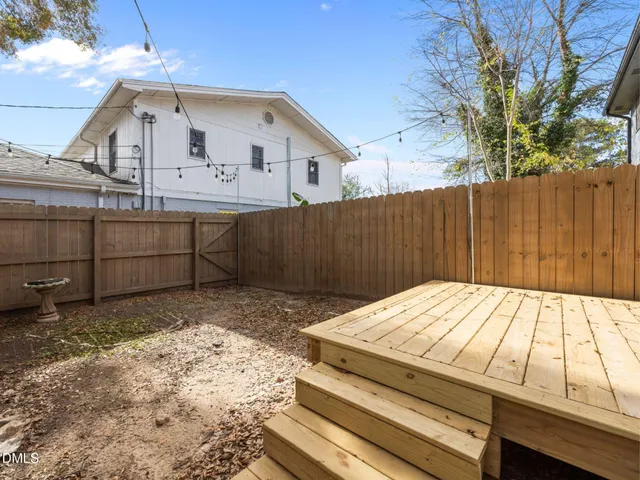 a view of a house with a wooden fence