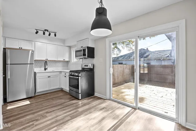 a kitchen with stainless steel appliances a stove a refrigerator and a sink