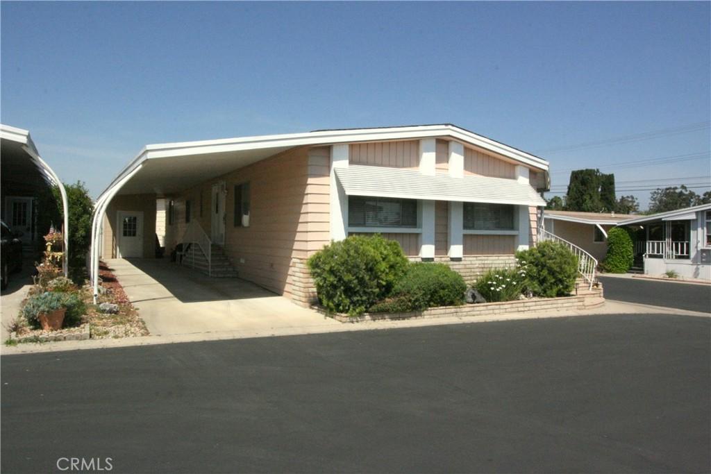 24701 Raymond Way, Unit 159 Lake Forest, CA 92630 - Photo 1 of 1 a front view of house with yard