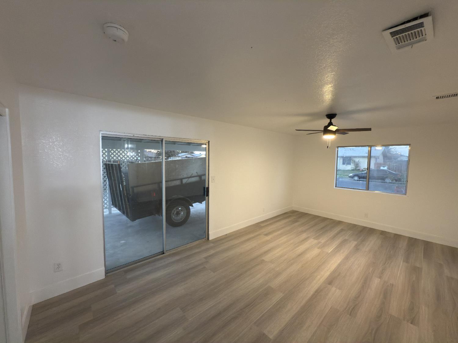21303 South Wyatt Avenue Riverdale, CA 93656 - Photo 11 of 14 an empty room with wooden floor and windows