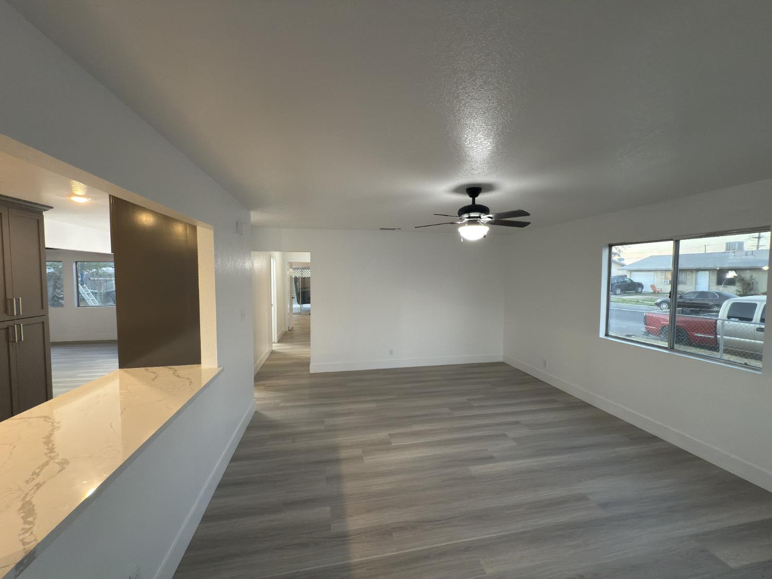 21303 South Wyatt Avenue Riverdale, CA 93656 - Photo 2 of 14 an empty room with wooden floor and windows