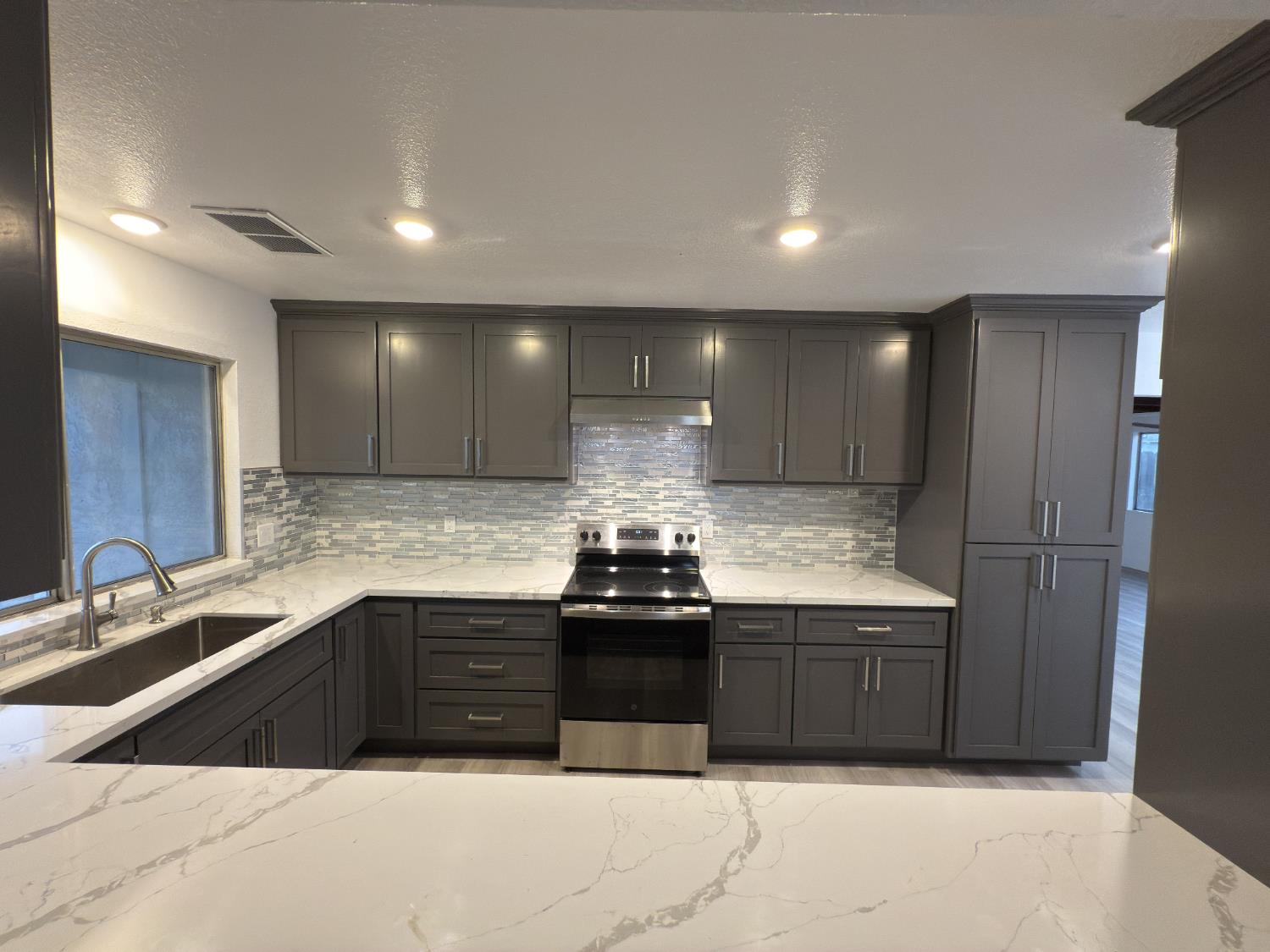 21303 South Wyatt Avenue Riverdale, CA 93656 - Photo 5 of 14 a kitchen with kitchen island sink and cabinets