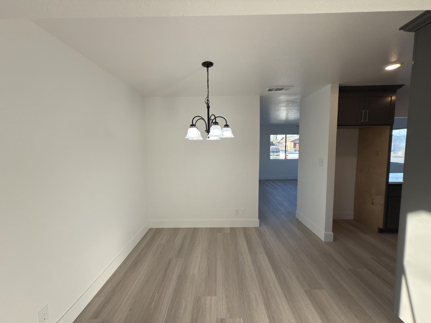 21303 South Wyatt Avenue Riverdale, CA 93656 - Photo 6 of 14 wooden floor in an empty room with a window