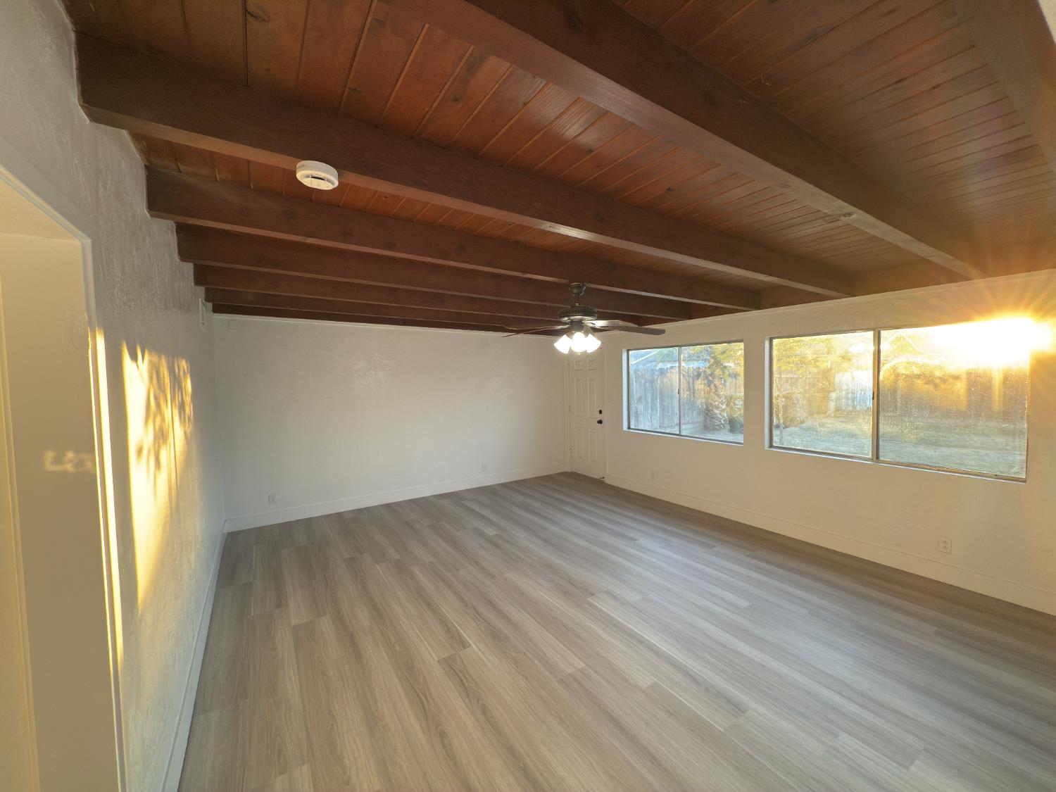 21303 South Wyatt Avenue Riverdale, CA 93656 - Photo 8 of 14 a view of an empty room with wooden floor and a window