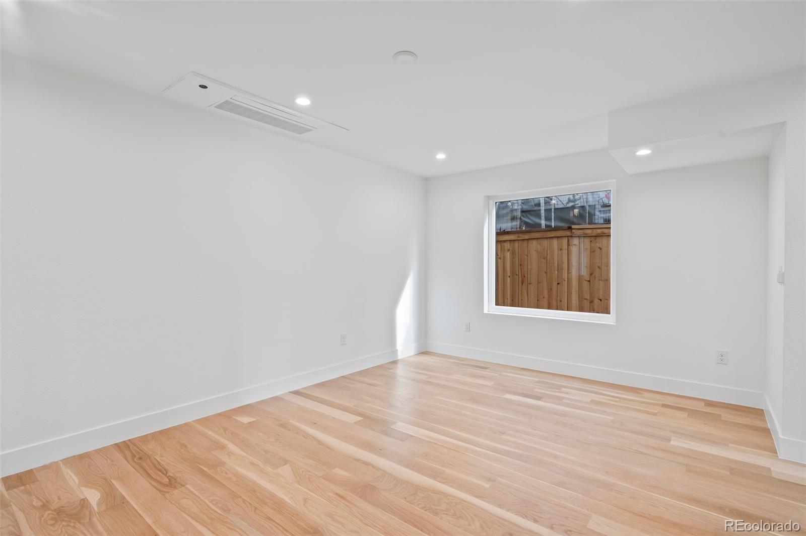 2451 Lawrence Street Denver, CO 80205 - Photo 18 of 48 a view of empty room with wooden floor