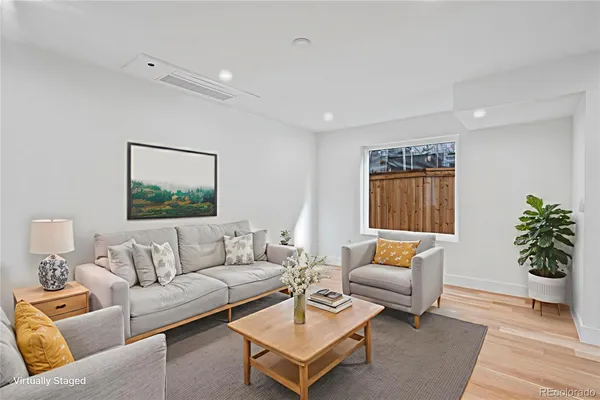 a living room with furniture and a potted plant