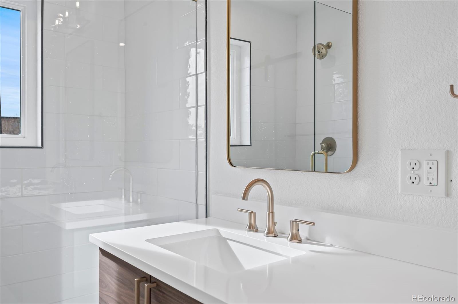 2451 Lawrence Street Denver, CO 80205 - Photo 24 of 48 a bathroom with a sink and a mirror