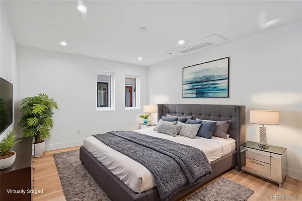 a bedroom with bed and a potted plant