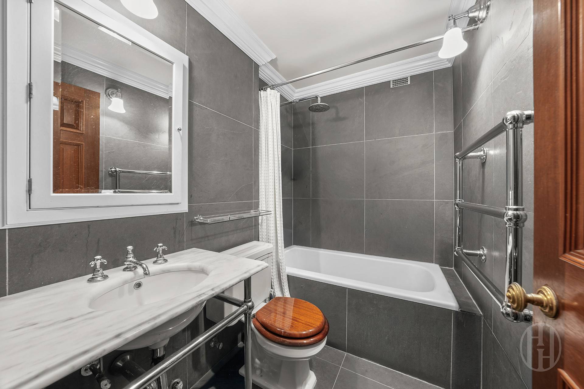 45 East End Avenue, Unit 10F Manhattan, NY 10028 - Photo 14 of 21 a bathroom with a sink a toilet and a mirror