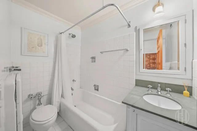 a bathroom with a granite countertop sink toilet a mirror and shower