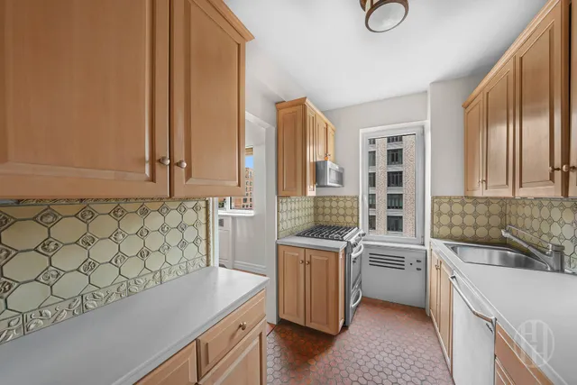 a kitchen that has a sink and a stove in it