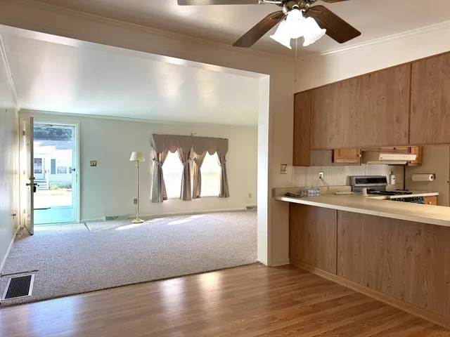 a view of kitchen with wooden floor and windows