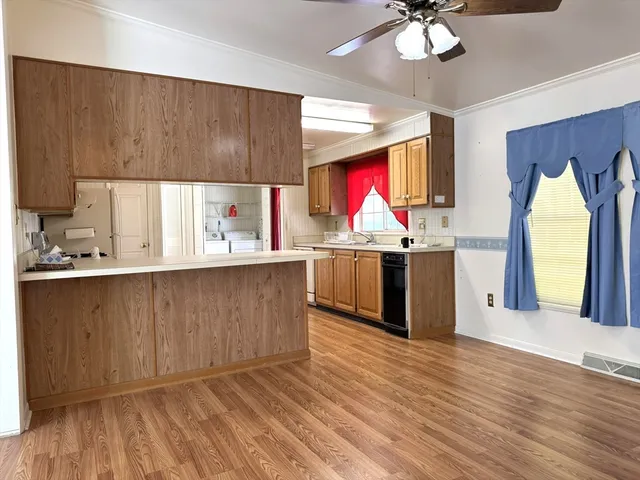 a kitchen with wooden cabinets and a stove top oven
