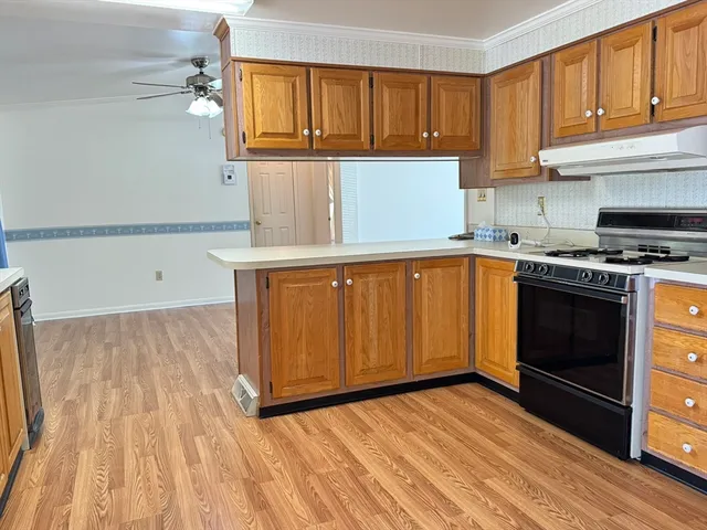 a kitchen with a sink a stove and cabinets