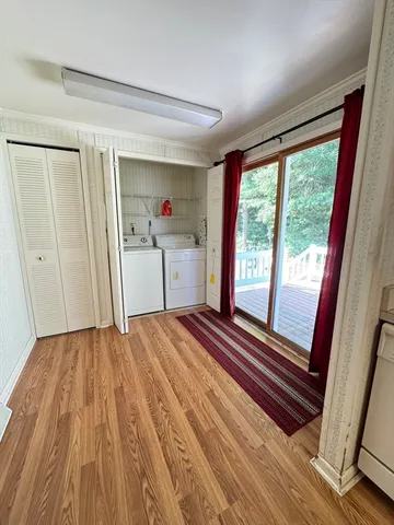 a view of a living room with fireplace and window