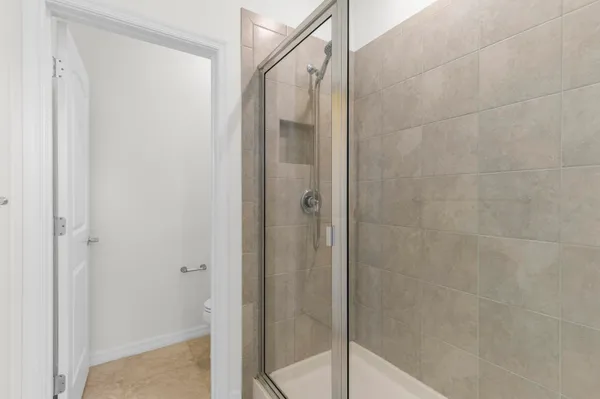 a bathroom with a glass shower door