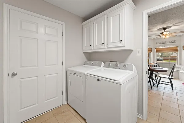 a utility room with closet dryer and washer