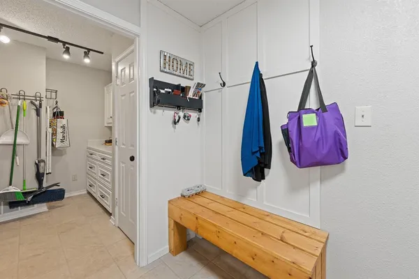 a room with a walk in closet and a mirror