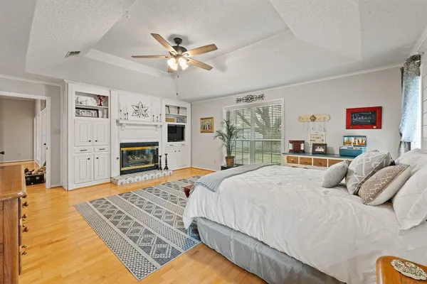 a bedroom with a large bed and a chandelier