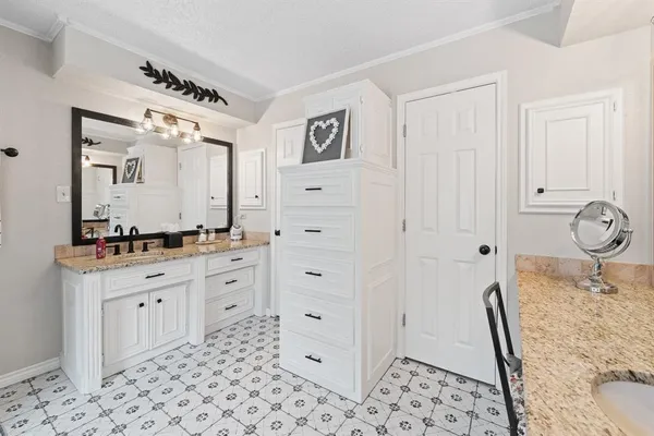 a spacious bathroom with a granite countertop sink and a mirror