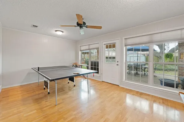 a living room with pool table and a window