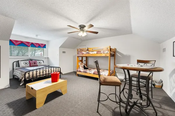 a bedroom with furniture and a chandelier