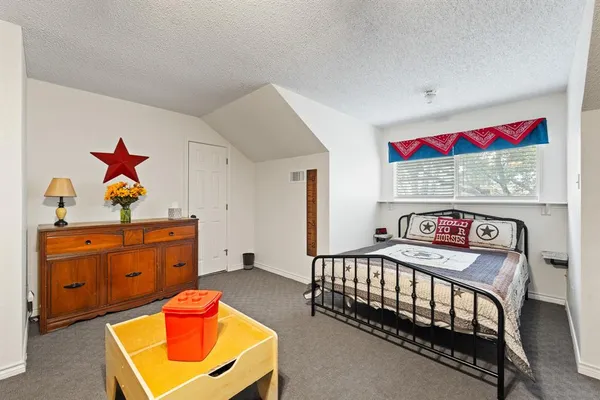 a bedroom with furniture and a dresser