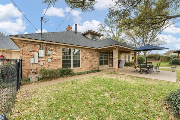 a view of a house with backyard porch and sitting area