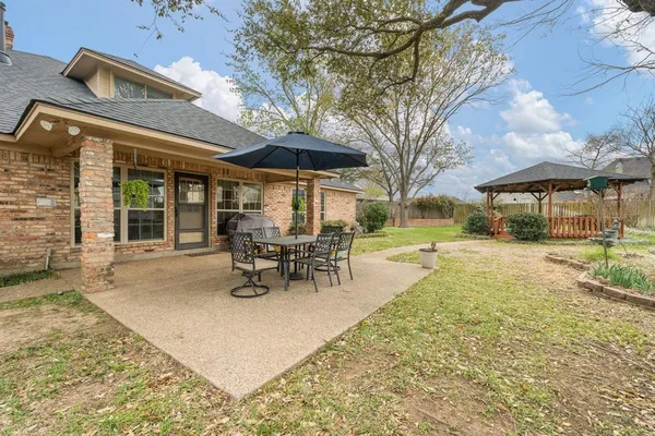 a view of a house with backyard porch and sitting area