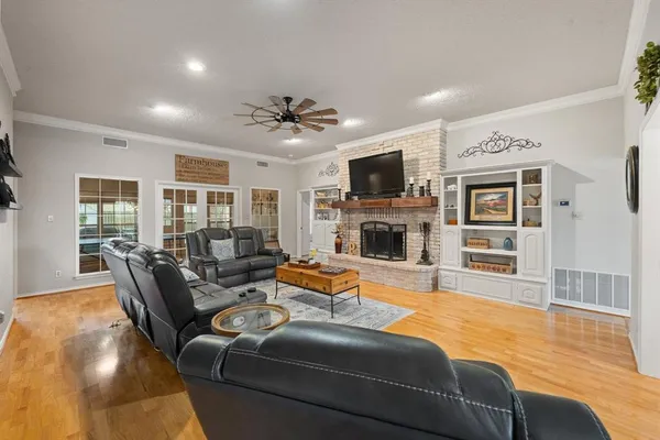 a living room with furniture a fireplace and a flat screen tv