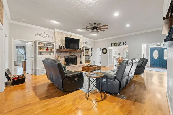 a living room with furniture a flat screen tv and a fireplace