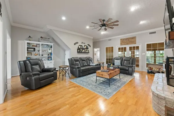 a living room with furniture fireplace and a large window