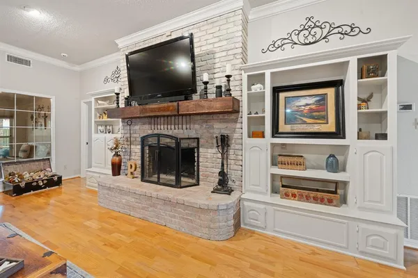 a living room with a flat screen tv and a fireplace