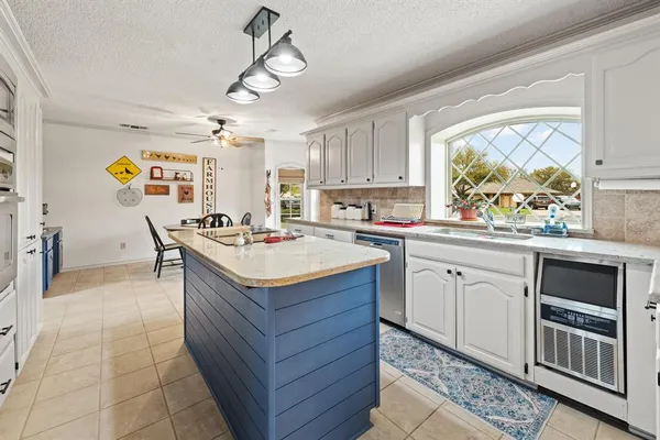 a kitchen with stainless steel appliances granite countertop a sink and a stove