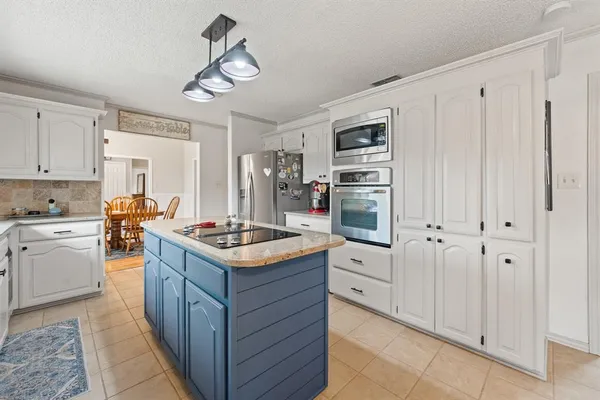 a kitchen with stainless steel appliances granite countertop a stove oven and a refrigerator