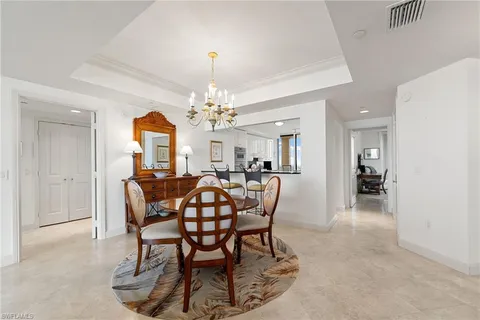a view of a dining room with furniture and chandelier