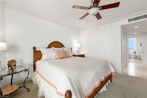 a bedroom with bed and a chandelier