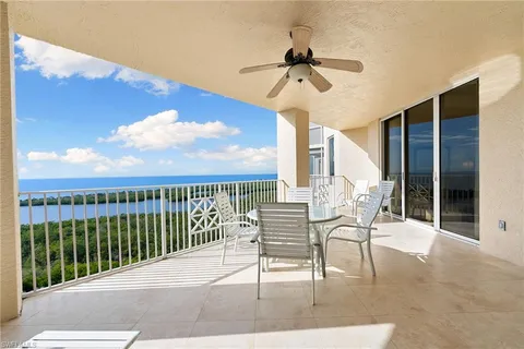 a view of a chair and tables in the balcony