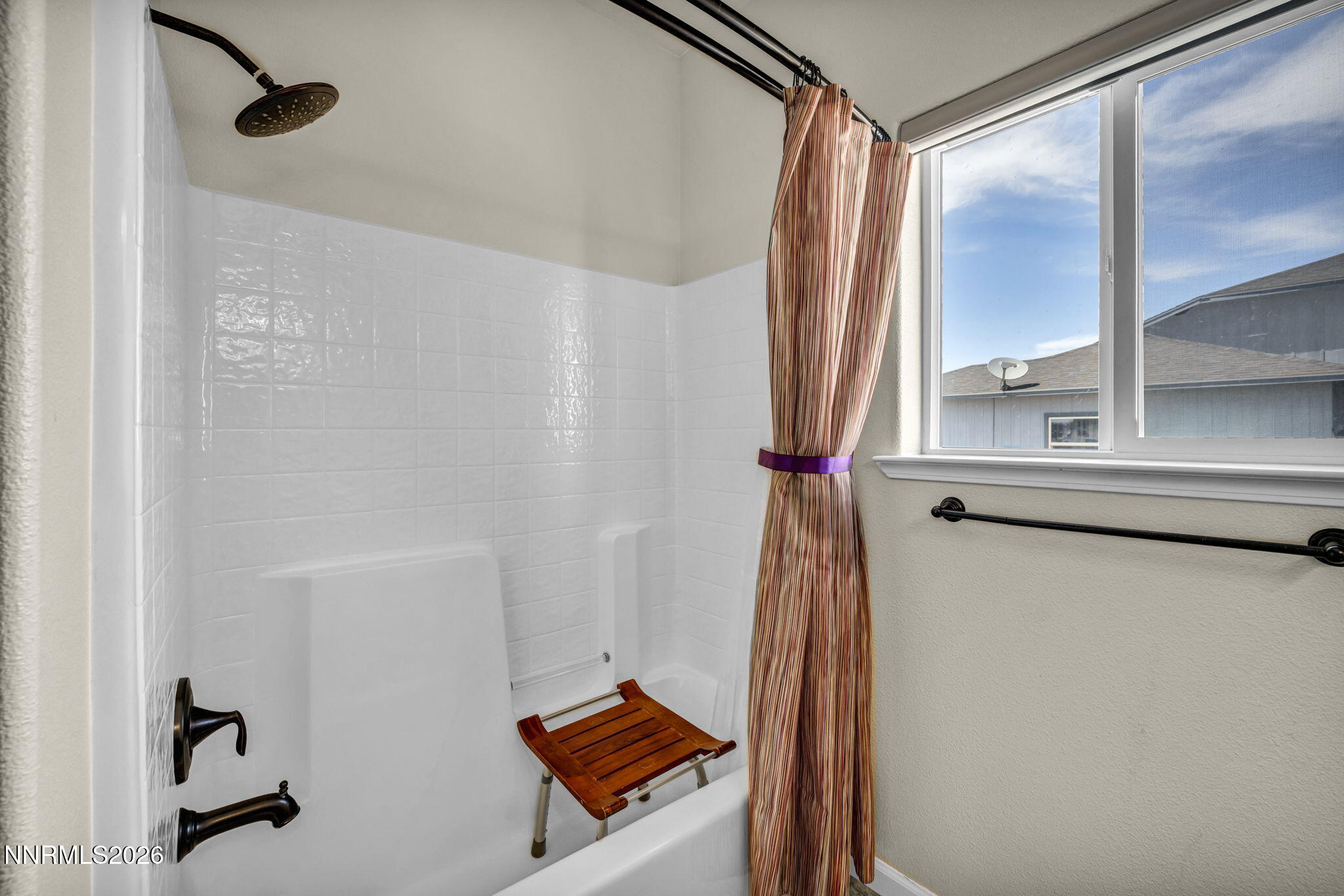 1286 Sky Ridge Drive Fallon, NV 89406 - Photo 33 of 49 a bathroom with a shower curtain and a window