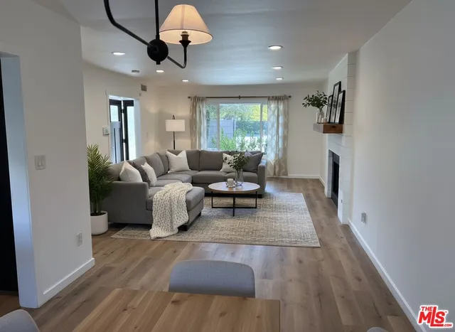 a living room with furniture and a chandelier
