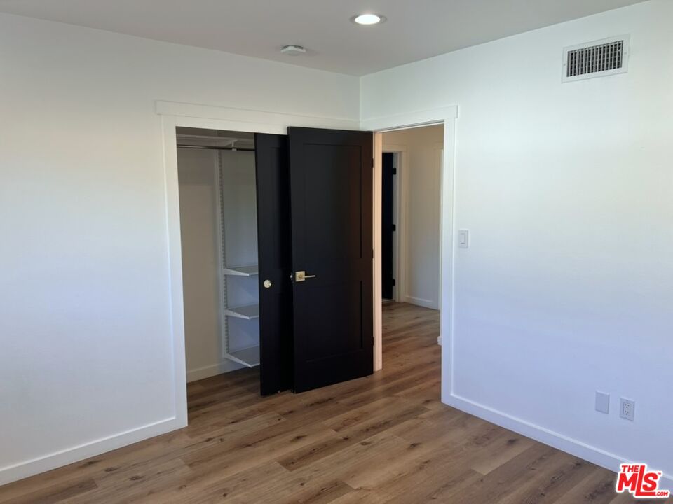 13123 West Magnolia Boulevard Sherman Oaks, CA 91423 - Photo 22 of 26 a view of an empty room with wooden floor