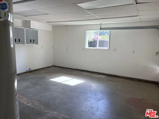 a view of a big room with wooden floor and windows