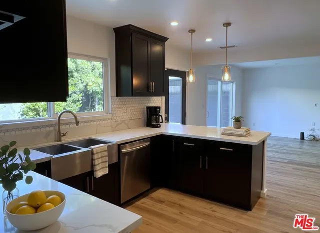 a kitchen with a sink stove and cabinets