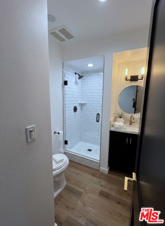 13123 West Magnolia Boulevard Sherman Oaks, CA 91423 - Photo 10 of 26 a bathroom with a sink a toilet and shower