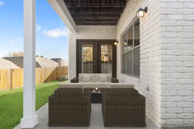 a living room with couches and balcony view with couch