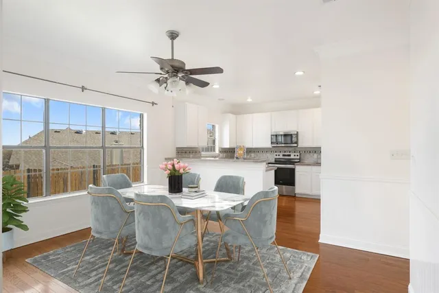 a dining room with furniture and a chandelier