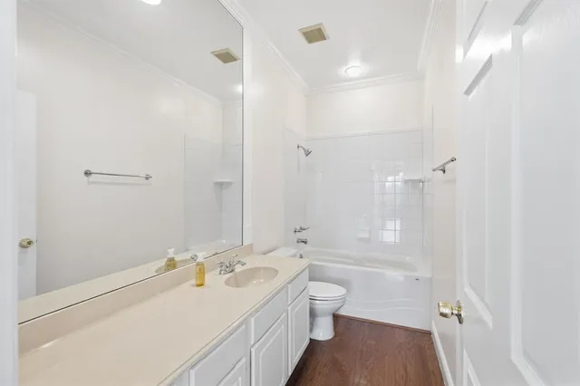 a bathroom with a double vanity sink toilet mirror and bathtub