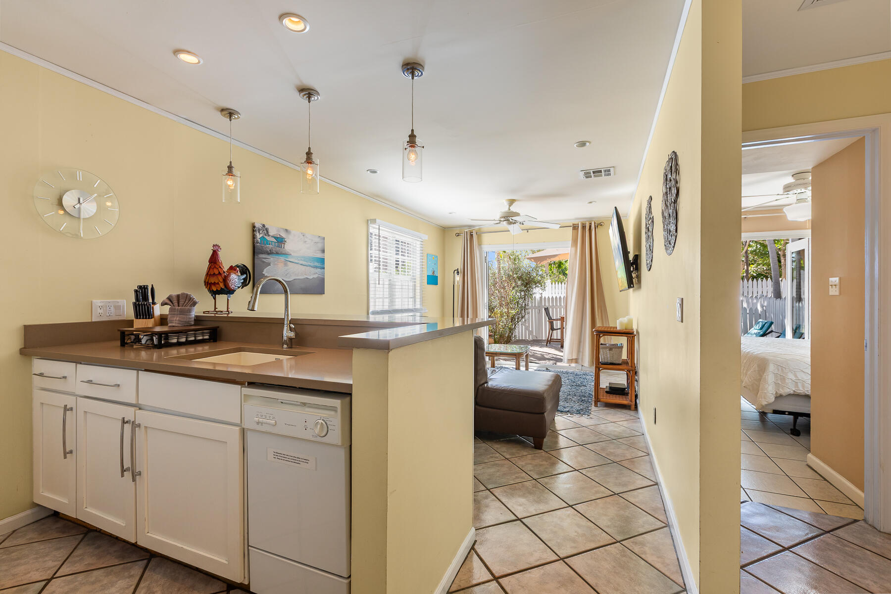 620 Thomas Street, Unit 175 Key West, FL 33040 - Photo 7 of 30 a large white kitchen with a sink and stainless steel appliances