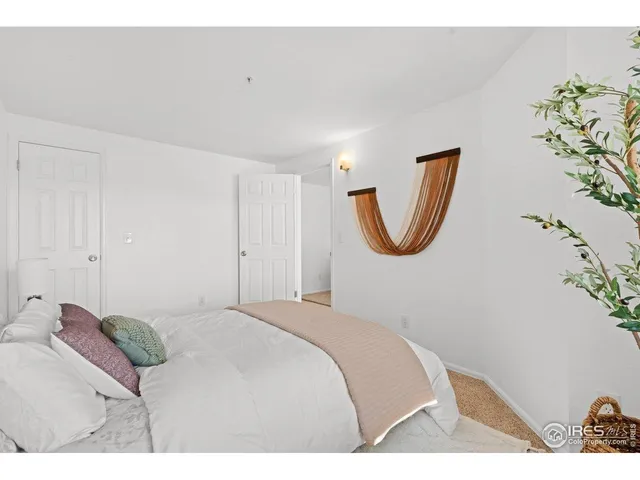 a bedroom with a bed and a painting on the wall