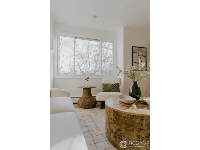 a living room with furniture a window and a fireplace